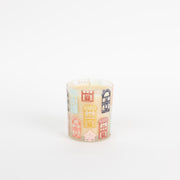 Candle with house-shaped wick on a white background