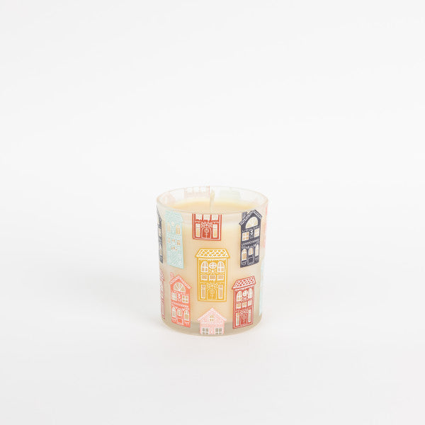 Candle with house-shaped wick on a white background